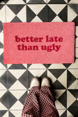 Lifestyle image of the Better Late Than Ugly Pink Doormat