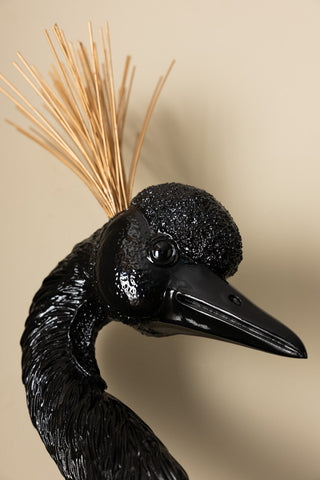 Close-up of the face of the Black & Gold Peacock Wall Art.