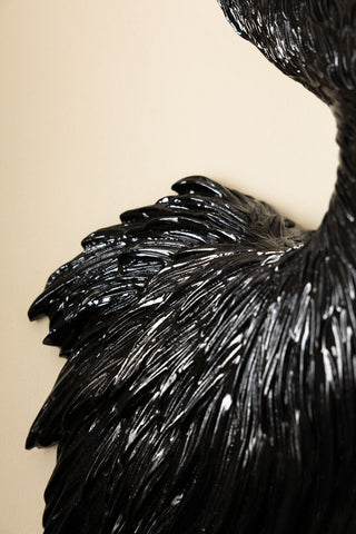 Close-up of the Black & Gold Peacock Wall Art in front of a neutral background.