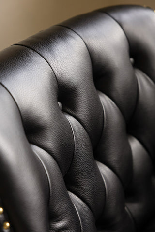 Close-up of the back of the Black Faux Leather Chesterfield Armchair.
