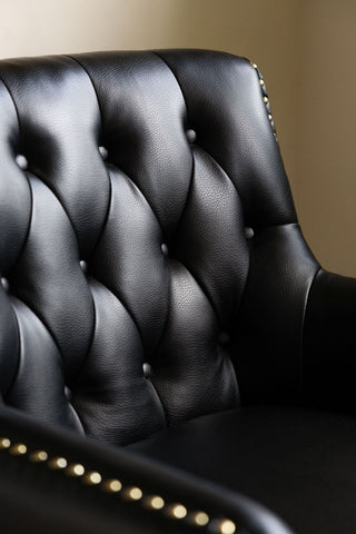 Close-up of the Black Faux Leather Chesterfield Armchair.
