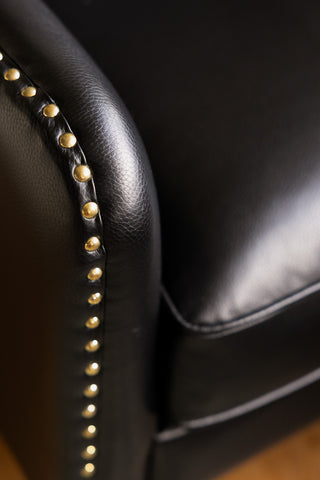 Close-up of the studs on the Black Faux Leather Chesterfield Armchair.