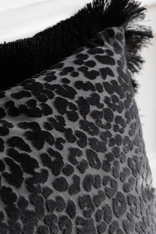Close-up of the Black Leopard Velvet Cushion with Fringe Trim.