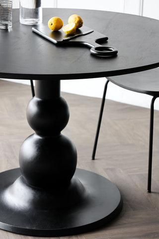 Close-up image of the Black Mango Wood Round Dining Table
