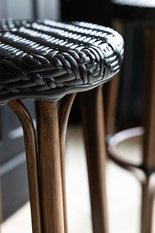 Detail of the black woven rattan on the bistro style bar stool.