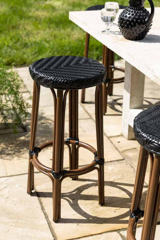 Lifestyle image of the Black Rattan Indoor/Outdoor Bar Stool