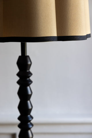 Close-up image of the Black Spindle Floor Lamp With Scalloped Shade