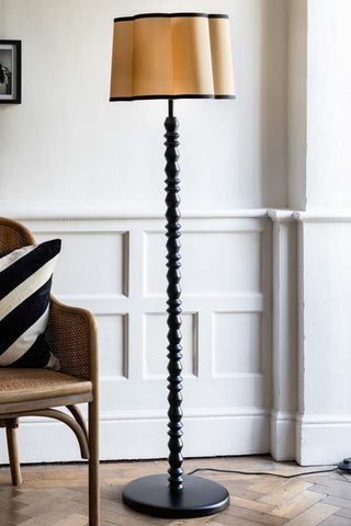 Lifestyle image of the Black Spindle Floor Lamp With Scalloped Shade