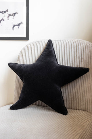 Lifestyle image of the Black Star Velvet Cushion