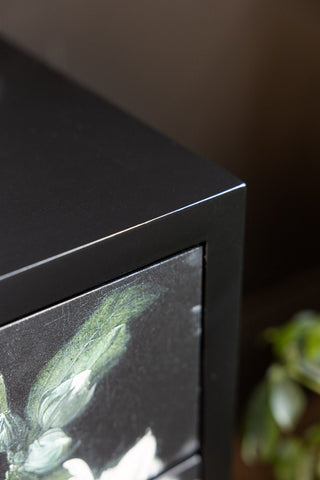 The corner of the Black Still Life Floral Bedside Table. 