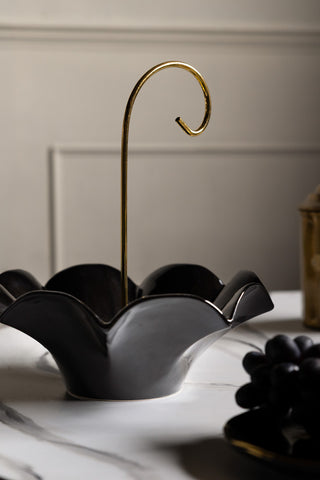 The Black Umbrella Fruit Bowl shown on a marble table. 