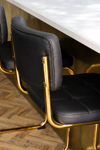Close-up image of the Black & Gold Faux Leather Retro Curve Bar Stool