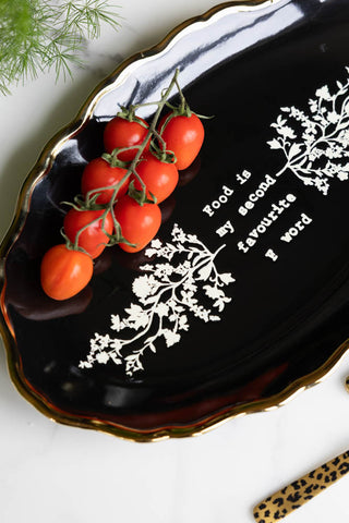 Close-up of the Black & Gold Floral F Word Serving Platter with some vine tomatoes on.
