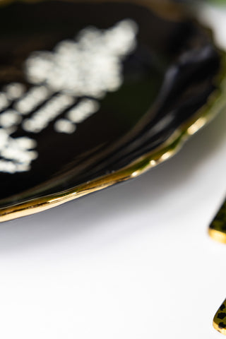 Close-up of the edge of the Black & Gold Floral F Word Serving Platter.