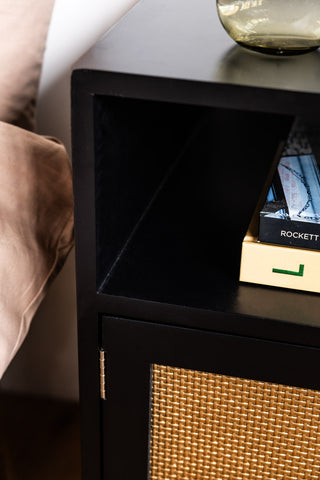 Close-up image of the Black & Gold Rattan Bedside Table