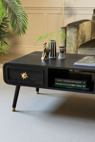 the curved corner of the Black & Gold Ringo Storage Coffee Table.