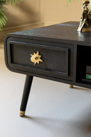 The drawer detail and gold star drawer handle of the Black & Gold Ringo Storage Coffee Table.