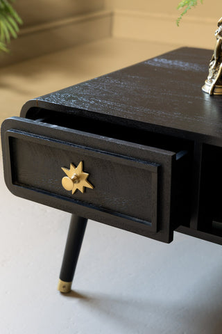 The open drawer of the Black & Gold Ringo Storage Coffee Table. 