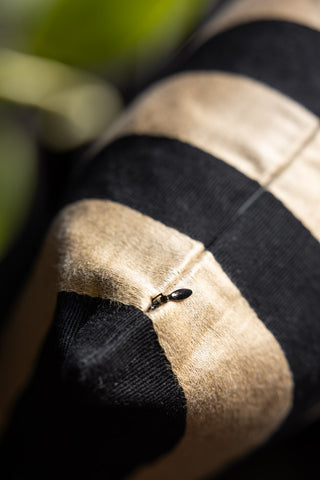 The hidden zip of the Black & Gold Stripe Cushion Cover. 