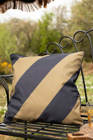 Lifestyle image of the Black & Green Stripe Outdoor Cushion