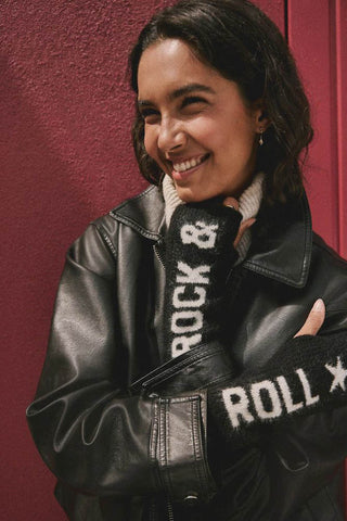 The Black & White Rock 'N' Roll Handwarmers being worn by a model with their hands up to their chest.