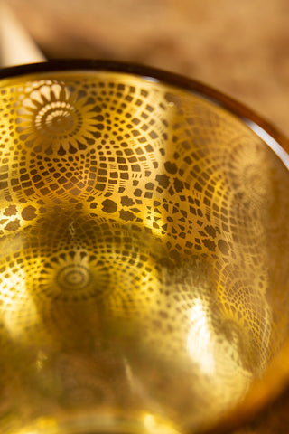 The gold interior of the Black & Gold Lace Pattern Glass Lantern. 