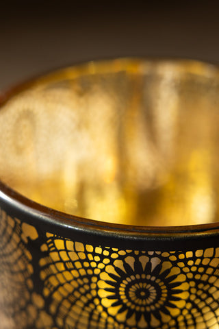 The gold interior and lace pattern of the Black & Gold Lace Pattern Glass Lantern. 