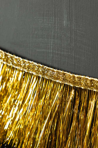 Close-up of the edge of the Black & Gold Scalloped Tinsel Garland.