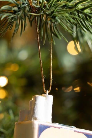 Close-up of the hanging loop of the Blue Cigarette Pack Christmas Tree Decoration hanging from a tree.