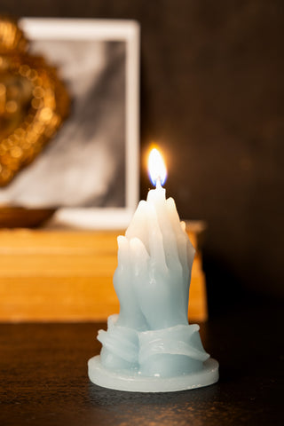 Lifestyle image of the Blue Praying Hands Candle