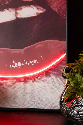 A detail shot of the Bold Red Lip Neon Wall Art, showing the red neon light outline of the lips. 