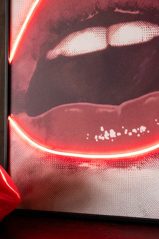 Close up of the Bold Red Lip Neon Wall Art  with the neon light switched on. 
