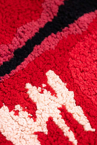 Close-up of the texture of a red lips bath mat.