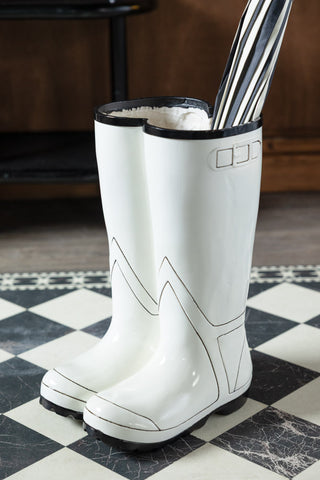 The Black & White Wellington Boot Umbrella Stand with an umbrella inside.