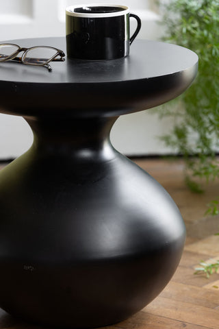 Detail image of the Bowl-Shaped Base Black Side Table in a lounge