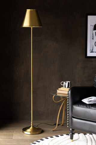 The Brass Slim Floor Lamp styled next to a side table and armchair.