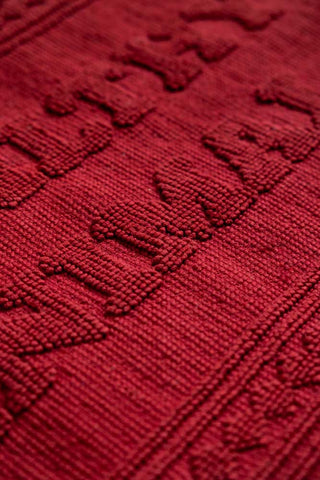 A detail image of the raised slogan text on the Filthy Animal Cherry Red Bath Mat.