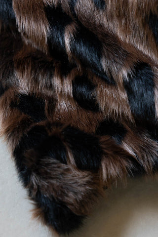 Detail of the corner of the Chocolate Abstract Faux Fur Throw. 