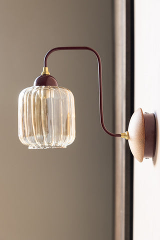 Lifestyle image of the Burgundy Metal & Ribbed Glass Wall Light