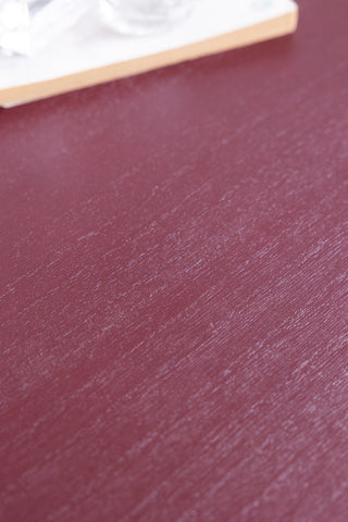 Close-up of the surface of the top of the Burgundy Rattan Bedside Table.
