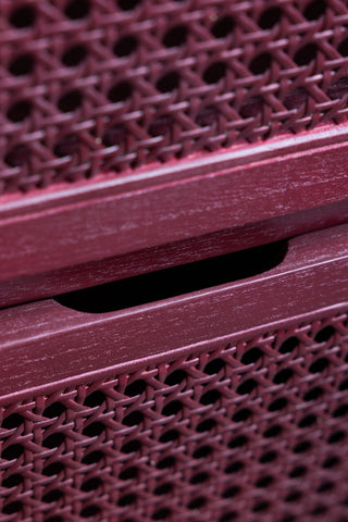 Close-up of the front of the drawers on the Burgundy Rattan Bedside Table.