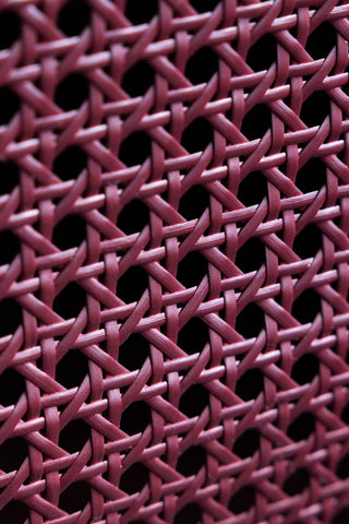 Close-up of the woven detail on the front of the drawers on the Burgundy Rattan Bedside Table.