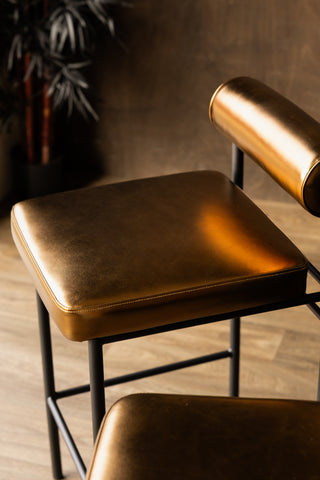 A closer image of the Burnished Gold Roll Back Bar Stool showing the seat