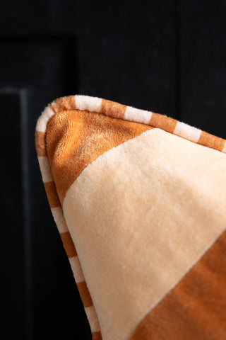 Close-up image of the Terracotta & Peach Diagonal Stripe Velvet Cushion