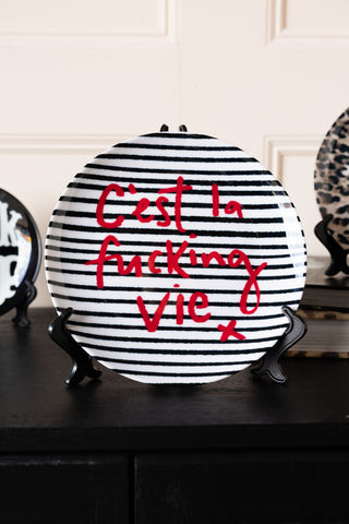 Image of the C'est La Fucking Vie Decorative Wall Plate on a stand