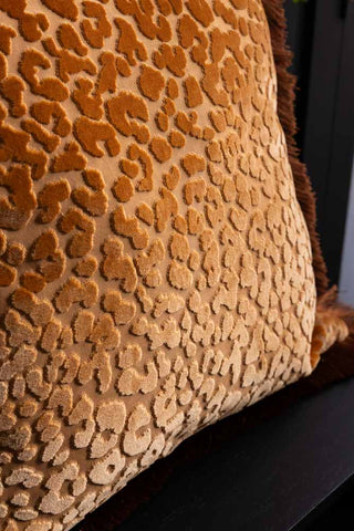 Close-up of the design on the Ochre Leopard Velvet Cushion with Fringe Trim.