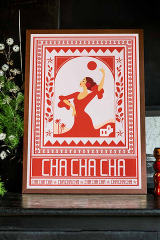 Styled image of the Cha Cha A2 Art Print in Red in a walnut frame on a dark background