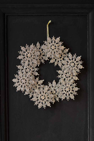 Lifestyle image of the Champagne Glitter Snowflake Wreath Decoration