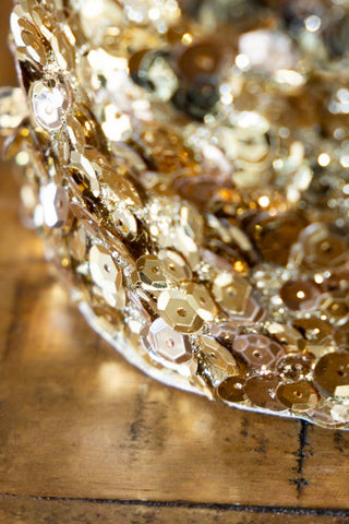 Detail image showing the sequins of the Champagne Gold Sequin Christmas Tree Cone catching the light. 