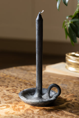 The Charcoal Dinner Candle & Wax Candle Plate shown unlit on a leopard coffee table. 